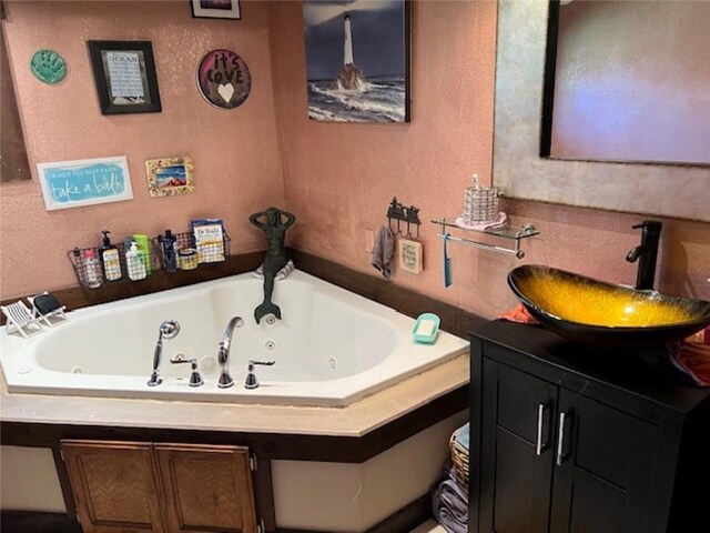 345 Old County D, Shell Lake, WI 54871 - full bathroom featuring a textured wall, vanity, and a whirlpool tub