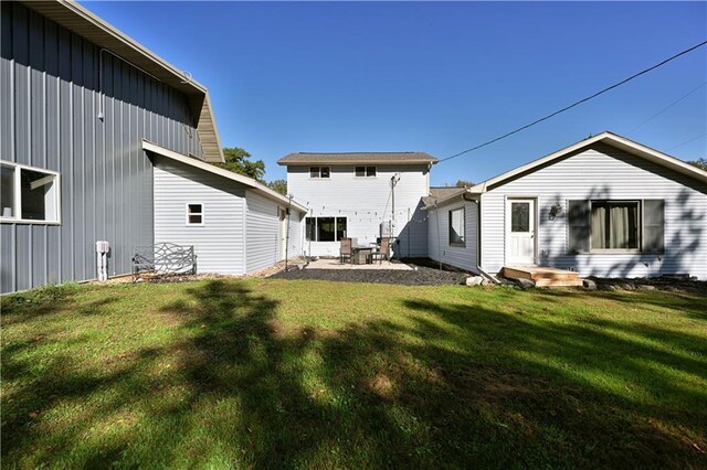 345 Old County D, Shell Lake, WI 54871 - rear view of house with a lawn, a patio, and board and batten siding