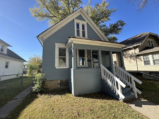 bungalow-style home featuring a porch and a front lawn