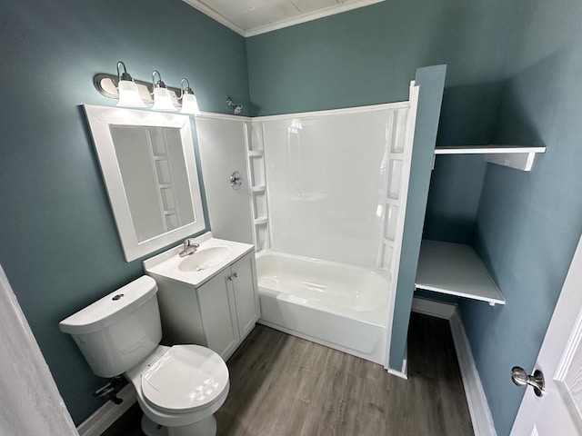 full bathroom with shower / washtub combination, toilet, vanity, hardwood / wood-style flooring, and ornamental molding