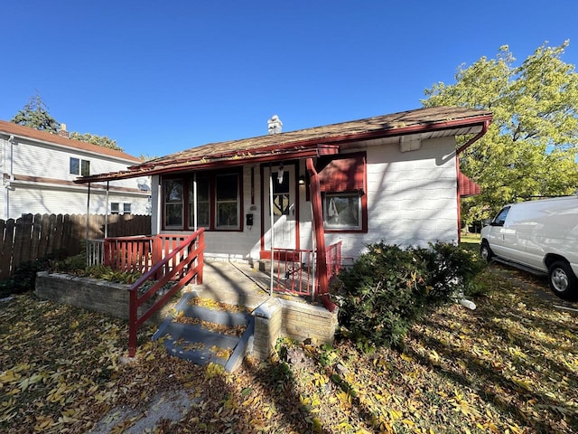 rear view of property with a porch