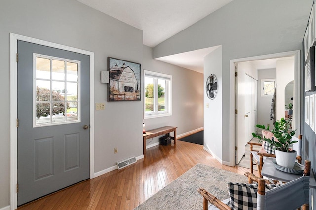 entrance foyer featuring light hardwood / wood-style floors, lofted ceiling, and plenty of natural light