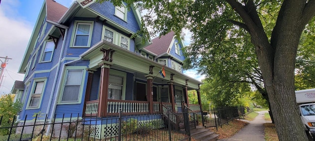 view of side of home with covered porch