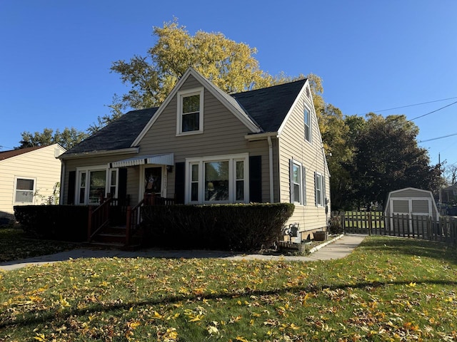 view of front of property with a front yard and an outdoor structure