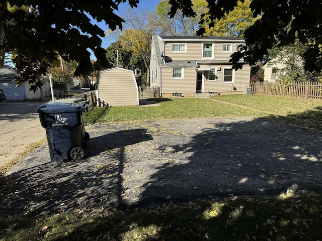 exterior space with a storage shed and a garage