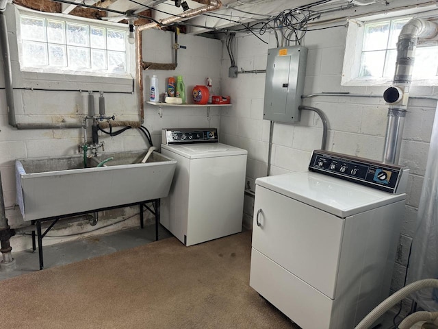 laundry room featuring sink, electric panel, and washing machine and clothes dryer