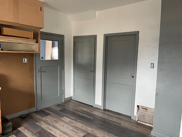 261 S Grant St, Adams, WI 53910 - unfurnished bedroom featuring dark wood-type flooring, baseboards, and a textured wall