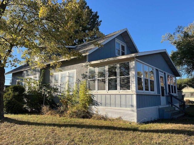 view of side of home featuring a lawn