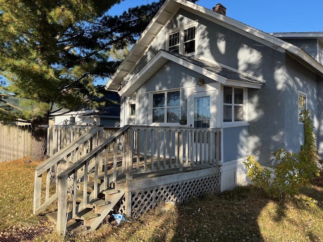 261 S Grant St, Adams, WI 53910 - rear view of property featuring a wooden deck, fence, and a chimney