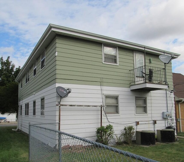 view of property exterior with cooling unit and a balcony