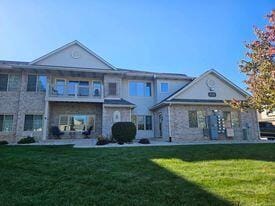 rear view of property with a yard