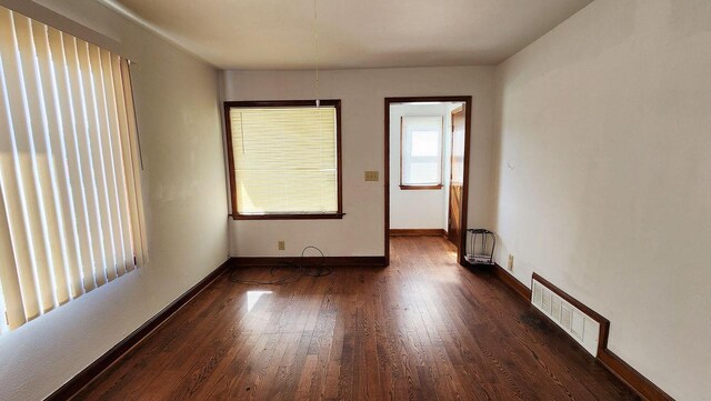 empty room featuring dark hardwood / wood-style flooring