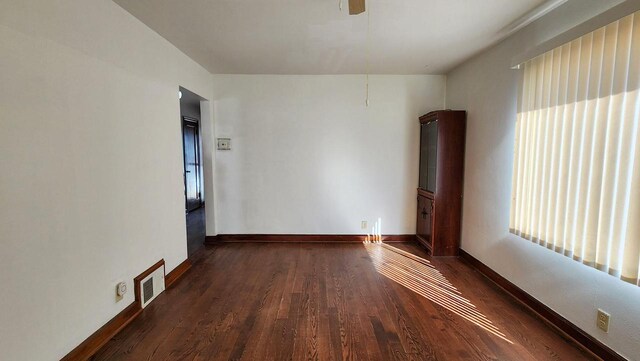 unfurnished room with dark hardwood / wood-style floors