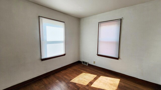 spare room featuring dark hardwood / wood-style flooring