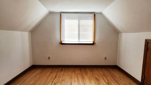 bonus room featuring vaulted ceiling and light hardwood / wood-style flooring