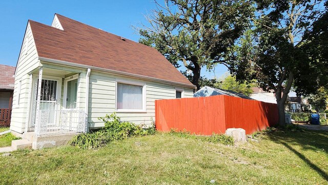 view of side of home featuring a yard