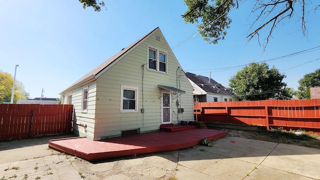 back of property featuring a wooden deck and a patio area