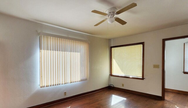 unfurnished room featuring dark hardwood / wood-style floors and ceiling fan