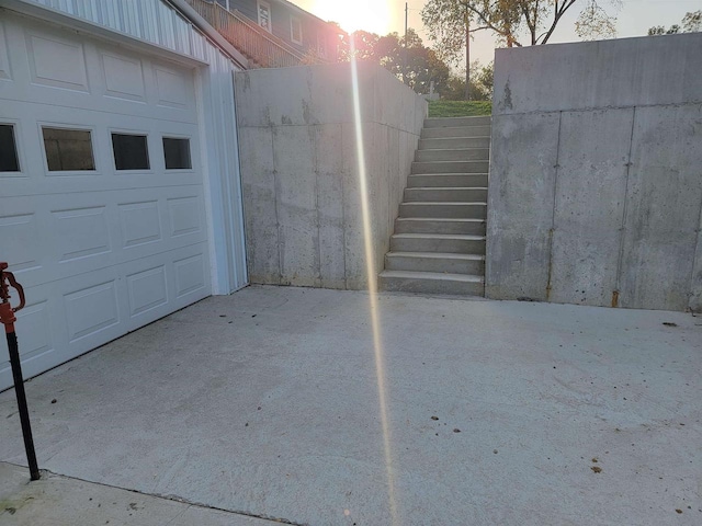 view of garage at dusk