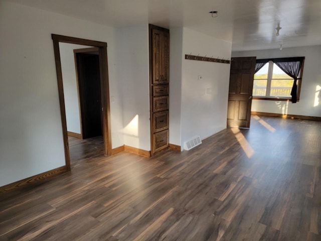 empty room with dark wood-type flooring