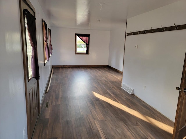 empty room with dark wood-type flooring