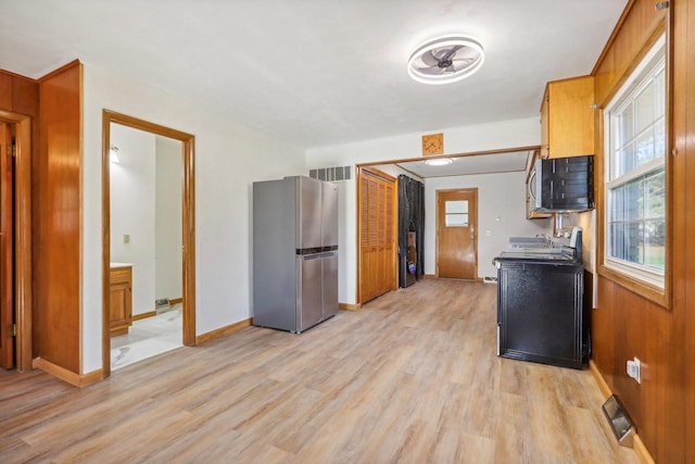 kitchen featuring light hardwood / wood-style floors, stainless steel refrigerator, and electric stove