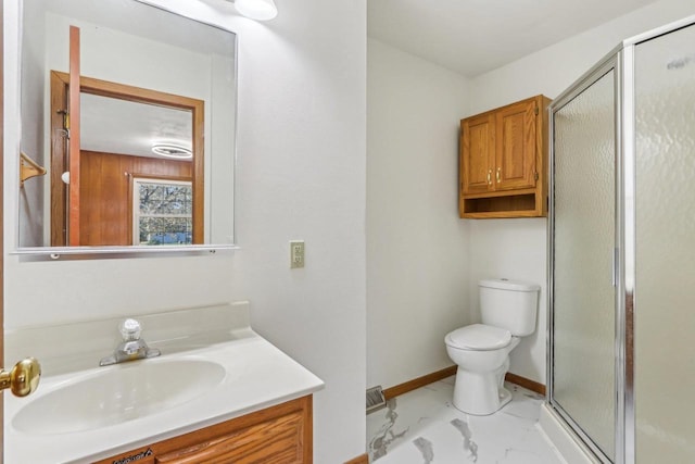 bathroom featuring vanity, walk in shower, and toilet