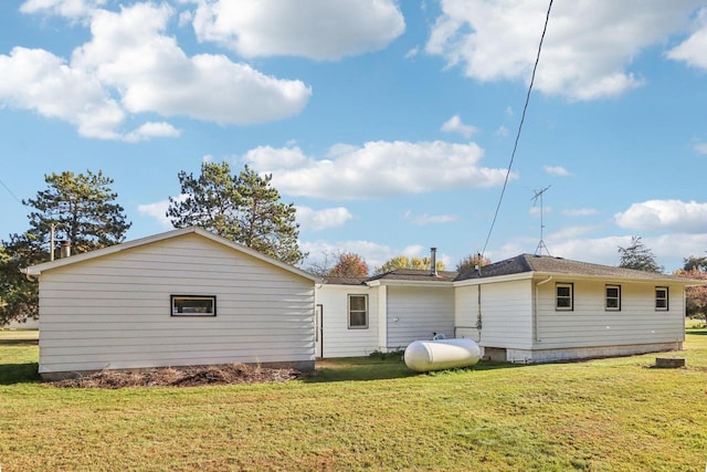 back of property with a lawn