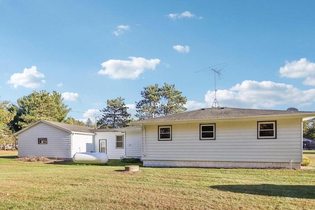 back of property featuring a lawn