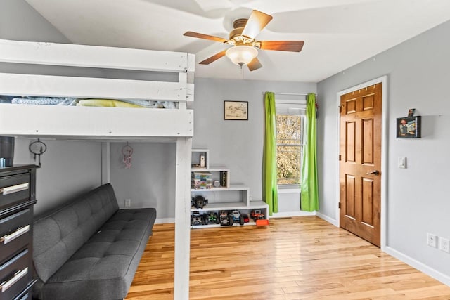 bedroom with light hardwood / wood-style floors and ceiling fan