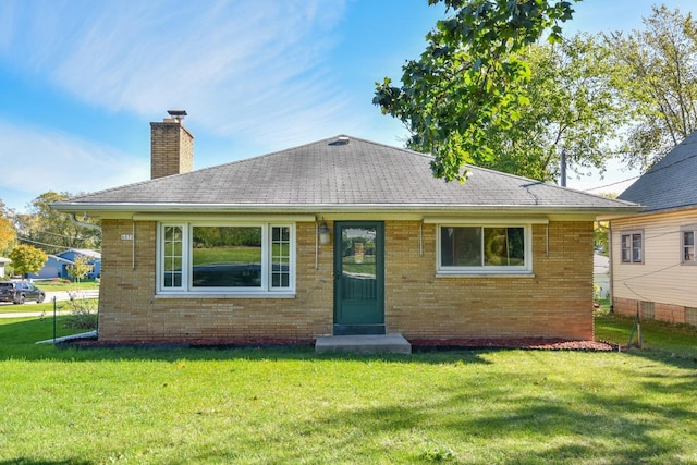 rear view of property with a yard