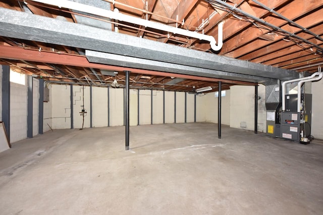 basement featuring electric panel and heating unit