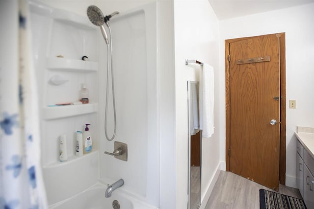 bathroom with vanity, hardwood / wood-style flooring, and bathing tub / shower combination