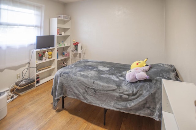 bedroom with hardwood / wood-style floors