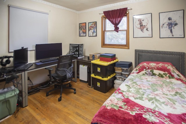 bedroom with crown molding and hardwood / wood-style flooring