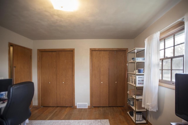 home office with wood-type flooring