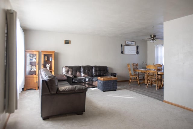 living room with ceiling fan and carpet