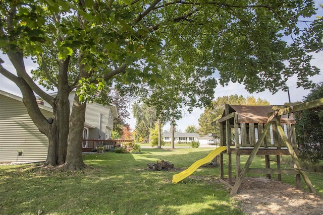 view of yard with a playground and a deck