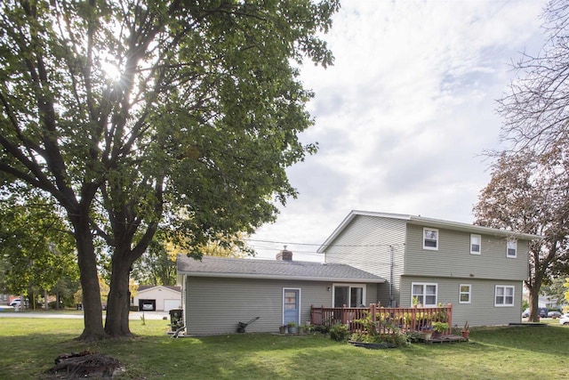 rear view of property with a wooden deck and a lawn