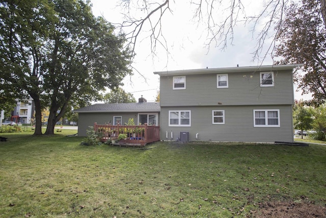 rear view of property featuring a wooden deck, a yard, and central AC unit