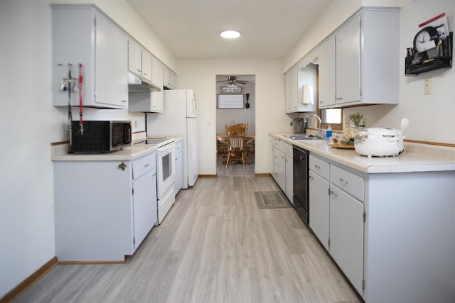 kitchen featuring sink, light wood-type flooring, white cabinets, white appliances, and ceiling fan