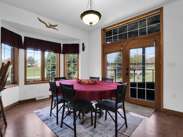 dining area with a wealth of natural light and wood-type flooring