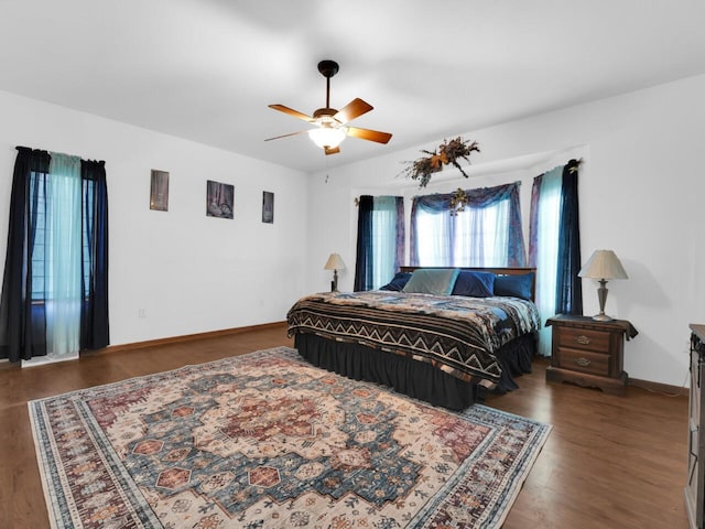 bedroom featuring ceiling fan and dark hardwood / wood-style floors