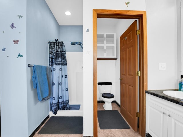 bathroom featuring a shower with shower curtain, vanity, and toilet