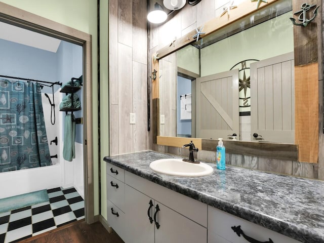 bathroom with shower / bath combo, vanity, hardwood / wood-style flooring, and tasteful backsplash