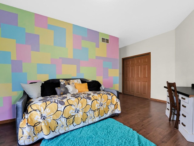 bedroom with a closet and dark hardwood / wood-style floors