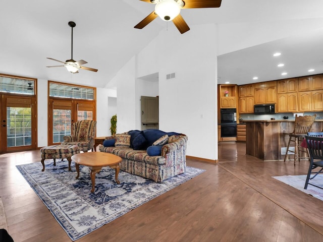 living room featuring high vaulted ceiling, ceiling fan, french doors, and dark hardwood / wood-style floors