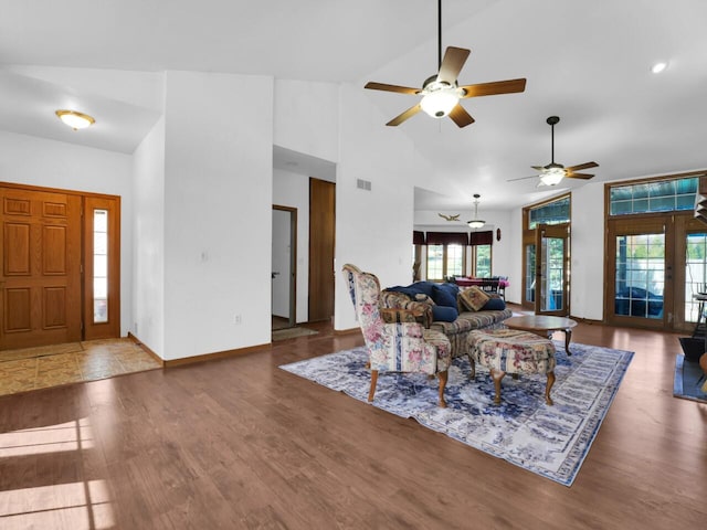 living room featuring french doors, high vaulted ceiling, a wealth of natural light, and dark hardwood / wood-style floors