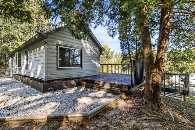 view of side of property with a wooden deck