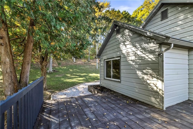 wooden deck featuring a yard